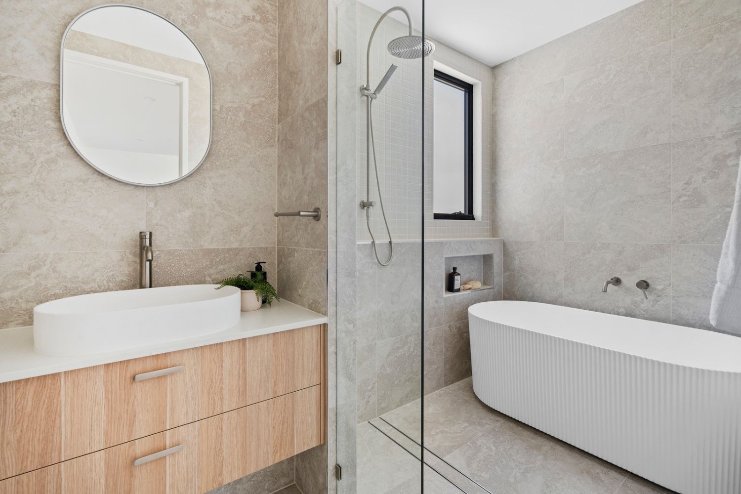 Bathroom with fluted freestanding bath, vessel basin and walk-in shower