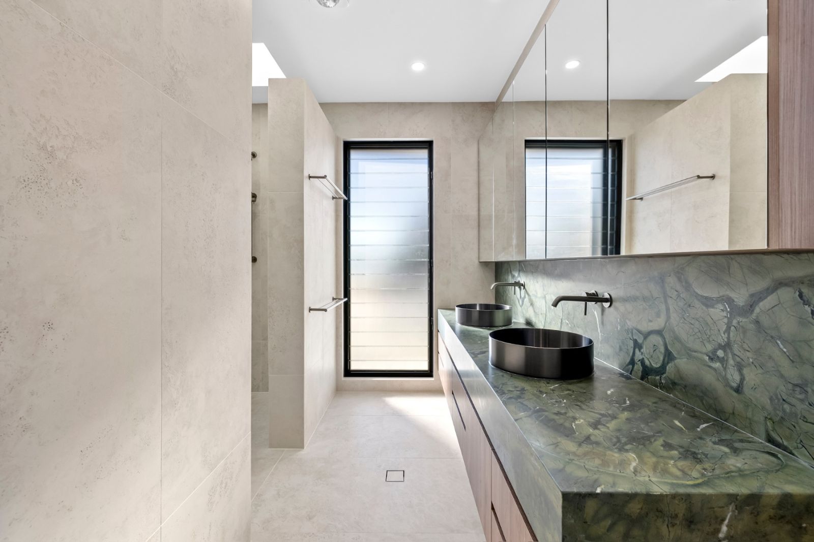 Completed walk-in shower with tiled bench seat on a new residential project